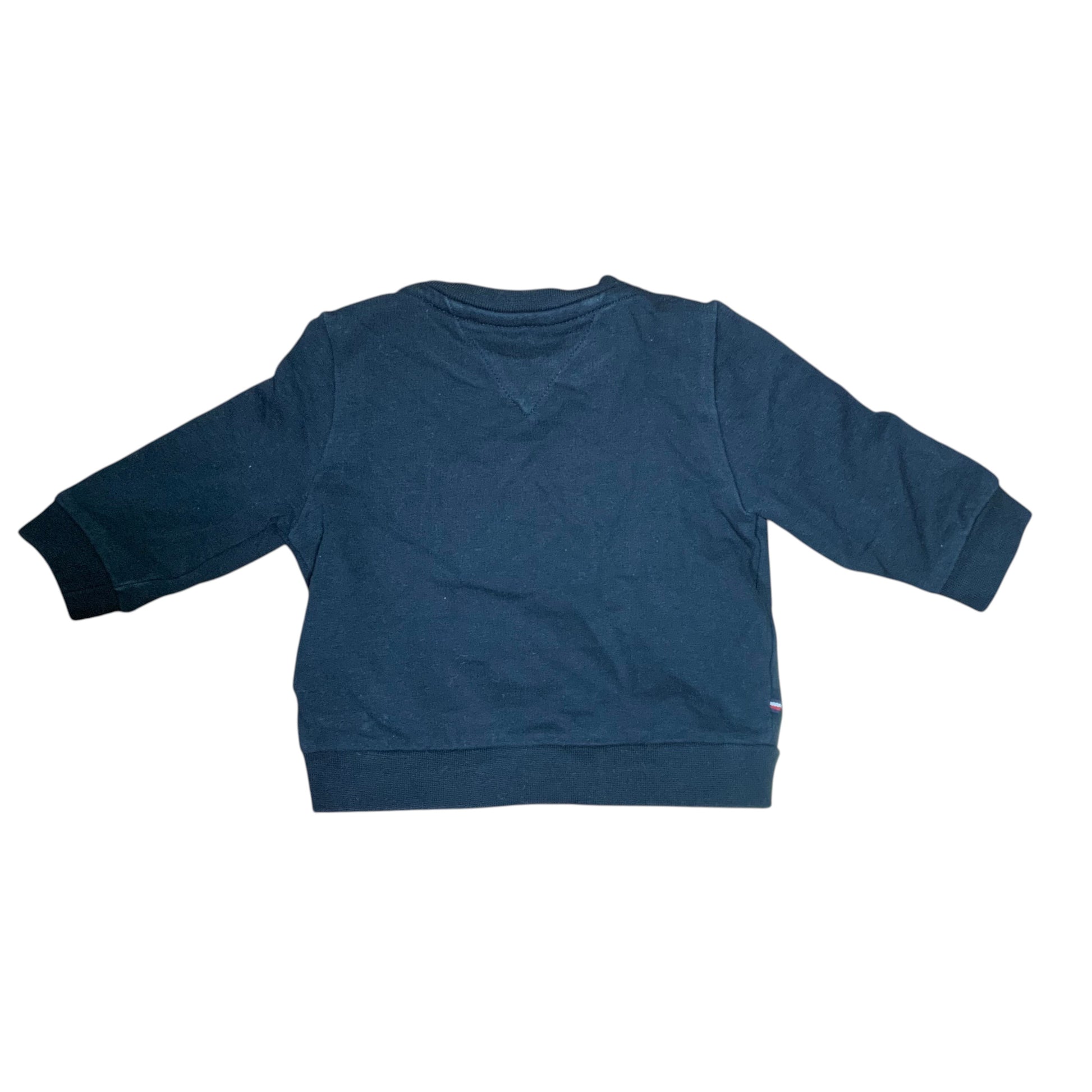 Back view of a black Amare Tutto Tommy tracksuit sweatshirt with ribbed cuffs and hem on a wooden floor.