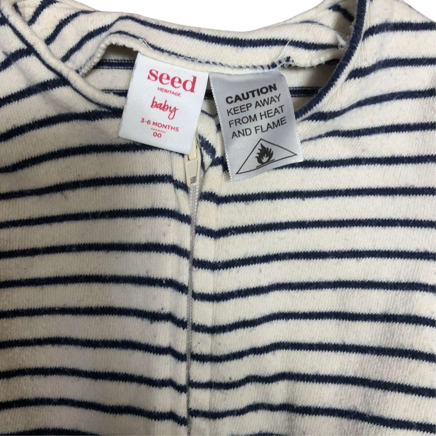 Amare Tutto Seed baby one piece in cream with navy blue horizontal stripes and front zipper closure