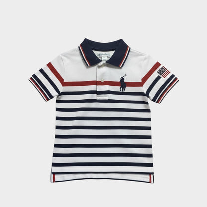 Amare Tutto white polo shirt for toddlers with navy and red stripes, USA flag patch, and embroidered logo