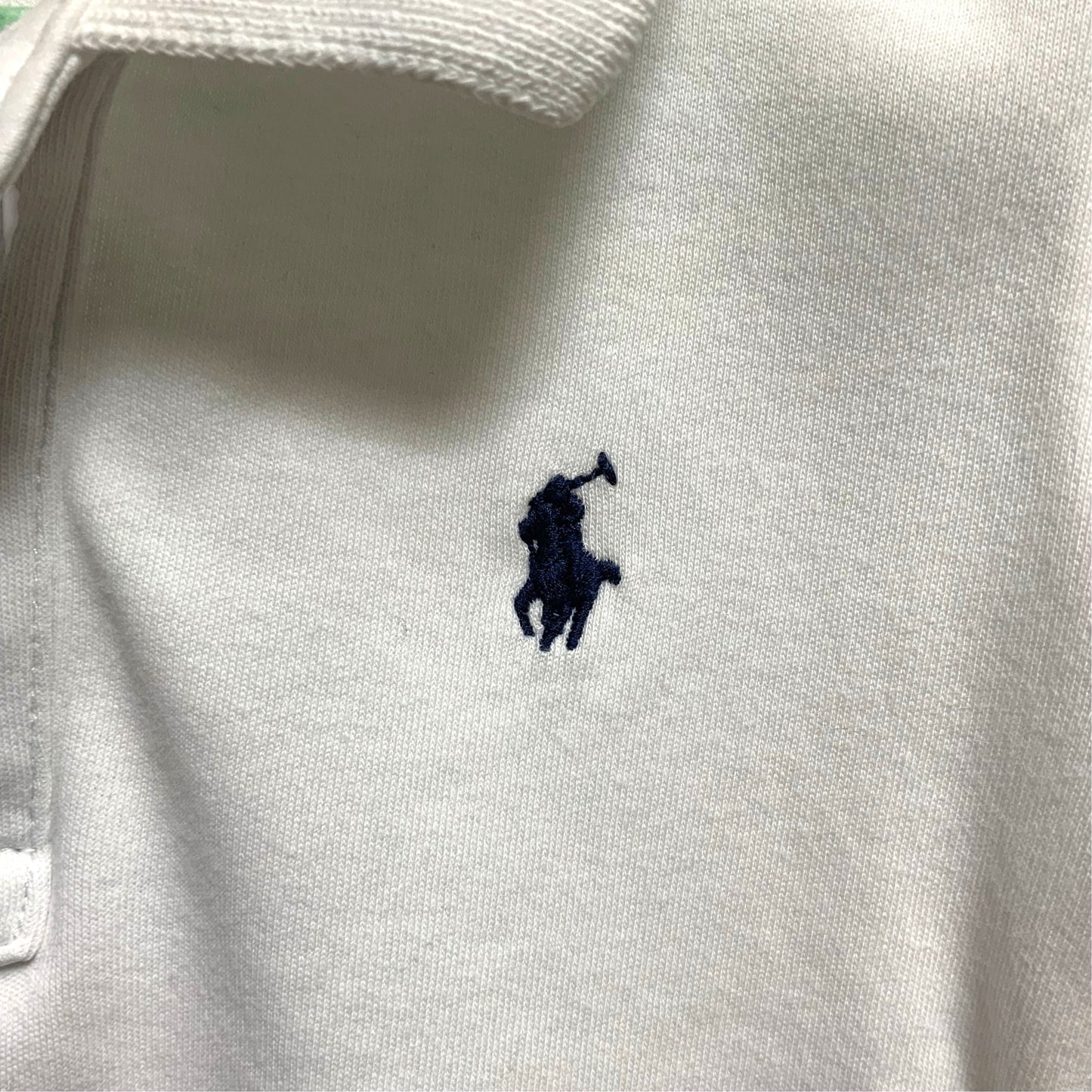 Amare Tutto white cotton baby polo shirt with signature navy embroidered pony logo on the chest
